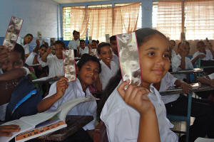 Panamanian school children are given bookmarks